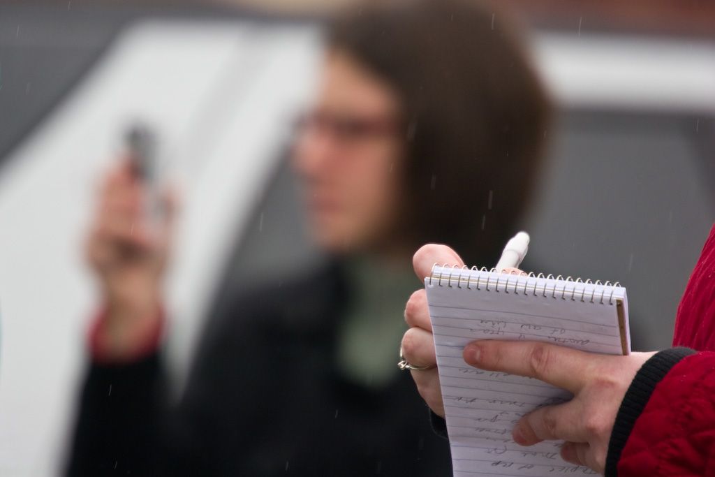Woman writing in a notebook.