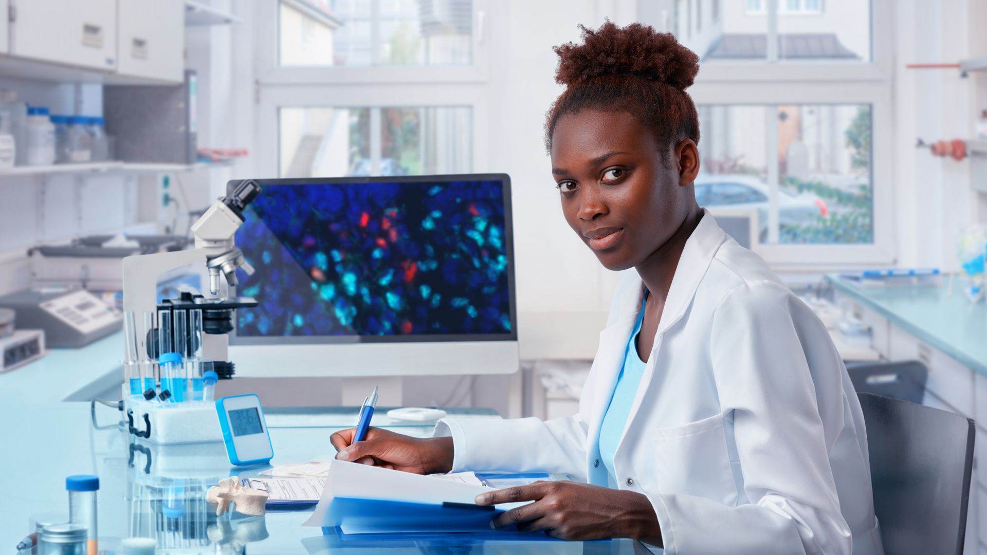 Scientist behind computer screen